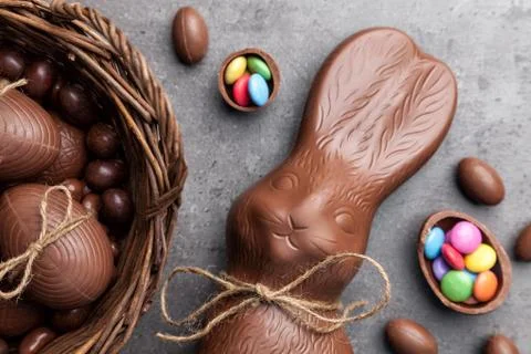 Chocolate Easter bunny and eggs on wooden background Stock Photos