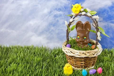 Chocolate Easter bunny in basket Stock Photos