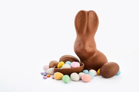 Chocolate easter bunny with candy eggs celebration Stock Photos