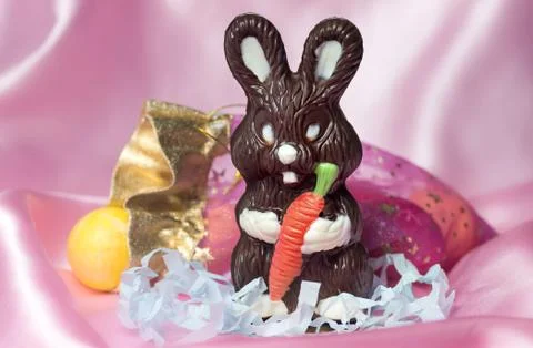 Chocolate easter bunny with colored eggs Stock Photos