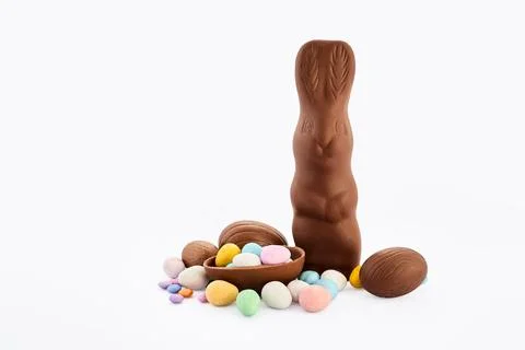 Chocolate easter bunny with decorated candy eggs Stock-Fotos