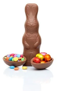Chocolate Easter bunny, eggs and sweets on white background Stock Photos