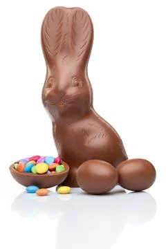 Chocolate Easter bunny, eggs and sweets on white background Stock Photos