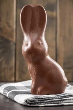 Chocolate Easter bunny, eggs and sweets on rustic background Stock Photos