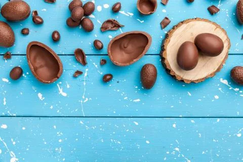 Chocolate Easter bunny, eggs and sweets on rustic background Stock Photos