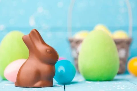 Chocolate Easter bunny, eggs and sweets on rustic background Stock Photos