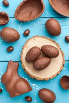 Chocolate Easter bunny, eggs and sweets on rustic background Stock Photos
