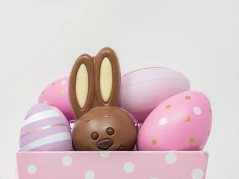 Chocolate Easter bunny hidden among Easter eggs Stock Photos