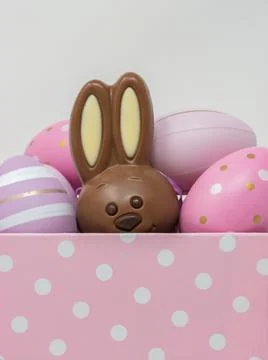 Chocolate Easter bunny hidden among Easter eggs Stock Photos