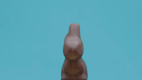 Chocolate Easter bunny on turntable with pastel colored background Stock Footage