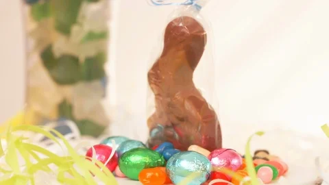 Chocolate Easter Bunny in Wrapper with Candy ROTATE LEFT Stock Footage 105879298