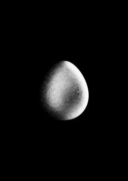 Chocolate easter egg with silver Aluminium foil on black background. Stock Photos