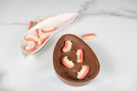 Chocolate Easter egg with strawberry and raspberry filling for children. Stock Photos