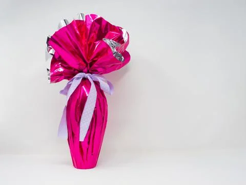 Chocolate Easter egg wrapped in pink silver foil Stock Photos