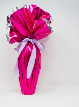 Chocolate Easter egg wrapped in pink silver foil Stock Photos