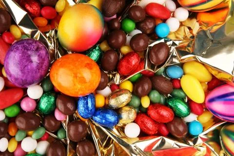 Chocolate Easter eggs and fresh eggs and colorful sweets Stock Photos