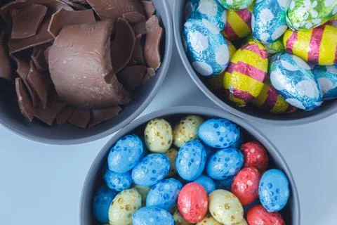 Chocolate easter eggs and pieces of a chocolate easter bunny Stock Photos