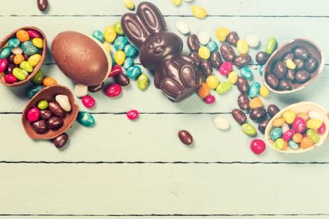 Chocolate Easter eggs and rabbit , on wooden background Stock Photos