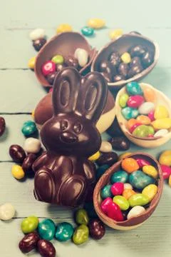 Chocolate Easter eggs and rabbit , on wooden background Stock Photos