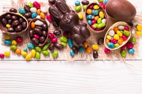 Chocolate Easter eggs and rabbit , on wooden background Stock Photos