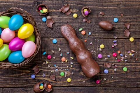 Chocolate easter eggs and sweets on wooden background Stock Photos