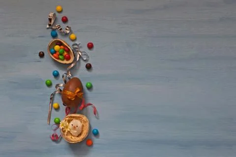 Chocolate Easter eggs and sweets on blue background Stock Photos