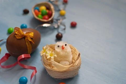 Chocolate Easter eggs and sweets on blue background Stock Photos