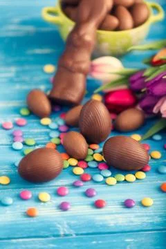 Chocolate easter eggs and tulips Stock Photos
