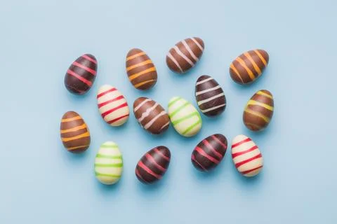 Chocolate easter eggs on blue background. Stock Photos
