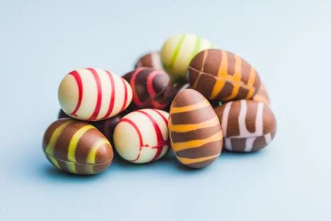 Chocolate easter eggs on blue background. Stock Photos