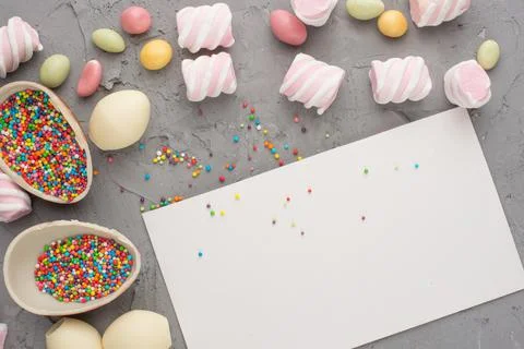 Chocolate easter eggs with a colored dragee. A top view, on a colored backgro Stock Photos