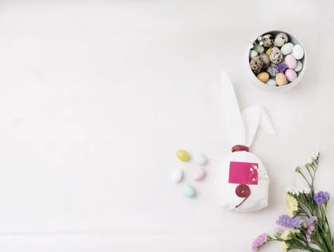 Chocolate Easter eggs glazed with pastel coloring and quail eggs in a bowl an Stock Photos