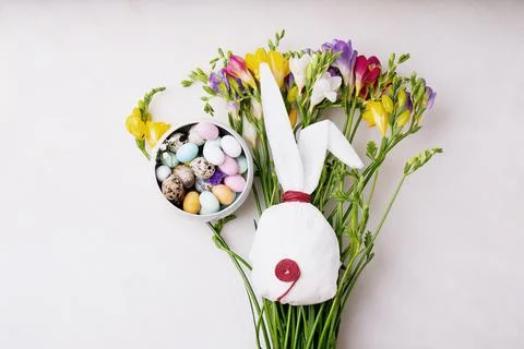Chocolate Easter eggs glazed with pastel coloring and quail eggs in a bowl ov Stock Photos
