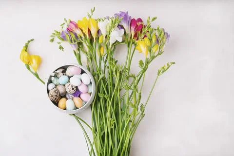Chocolate Easter eggs glazed with pastel coloring and quail eggs in a bowl ov Stock Photos