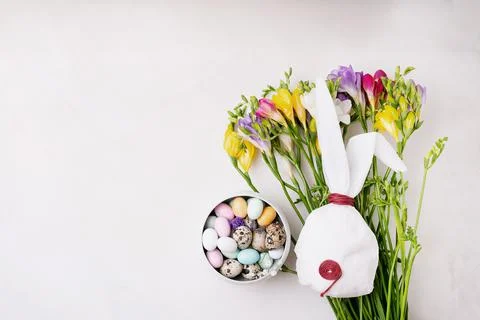 Chocolate Easter eggs glazed with pastel coloring and quail eggs in a bowl ov Stock Photos