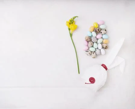Chocolate Easter eggs glazed with pastel coloring and quail eggs over white b Stock Photos