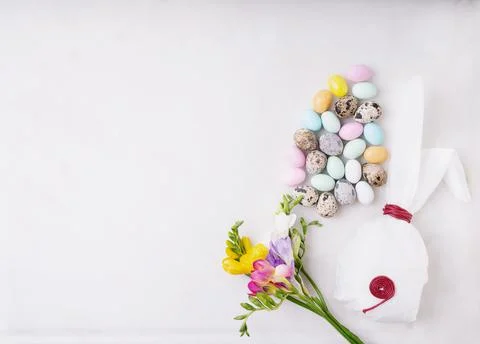 Chocolate Easter eggs glazed with pastel coloring and quail eggs over white b Stock Photos