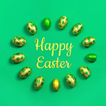 Chocolate easter eggs in gold and green foil in round with the sign Happy Easter Stock Photos