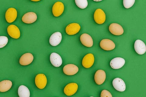 Chocolate Easter eggs on green background Stock Photos