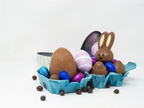 Chocolate Easter eggs with a happy Easter bunny Stock Photos
