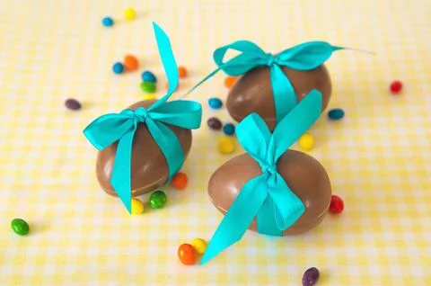 Chocolate Easter eggs over yellow tablecloth Stock Photos