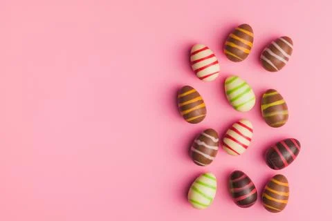 Chocolate easter eggs on pink background. Stock Photos