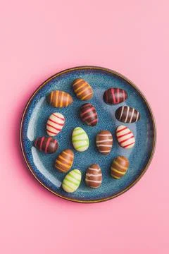 Chocolate easter eggs on pink background. Stock Photos