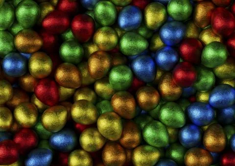 Chocolate easter eggs with red, orange, blue, green and yellow foil. Stock Photos