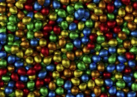 Chocolate easter eggs with red, orange, blue, green and yellow foil. Stock Photos