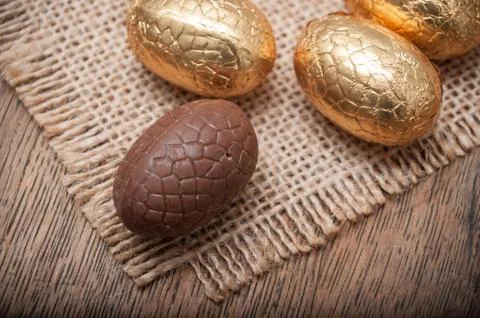 Chocolate easter eggs on wooden table background Stock Photos