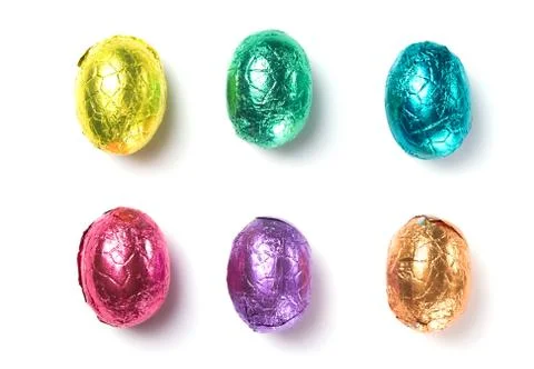 Chocolate easter eggs wrapped in multi colored foil isolated on white Stock Photos