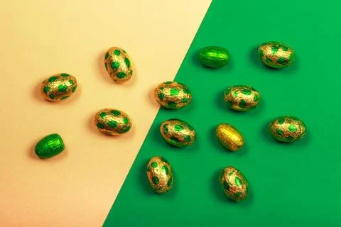 Chocolate easter eggs wrapped in yellow and green colored foil Stock Photos