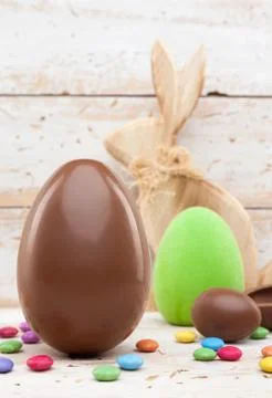 Chocolate Easter holiday egg on rustic backround Stock Photos