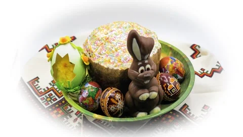 Chocolate Easter rabbit with decorated eggs and cake on towel with ornament Stock Footage 276312903